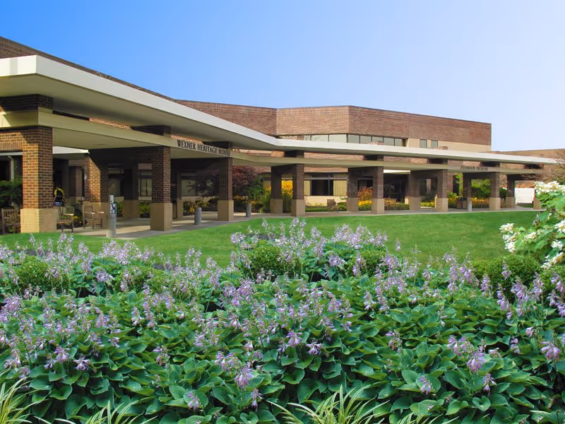 Front view of Wexner Heritage Village entrance with landscaped flower bed in foreground