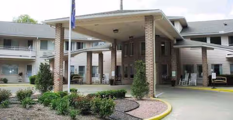 Exterior view of Independence Village of Evansville with a covered entrance and landscaping.