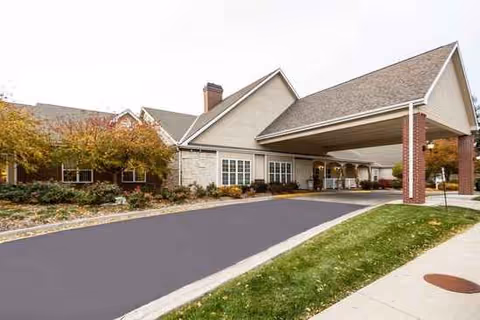 Exterior view of Marquis Place of Elkhorn with a covered entrance and driveway.