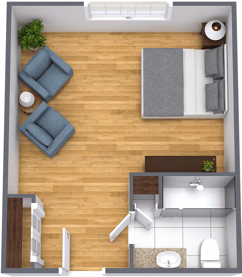 Top-down view of a small apartment layout featuring a bedroom area with a bed, two blue armchairs with a small round table and lamp between them, a bathroom with a shower, toilet, and sink, and a small kitchenette area with cabinets and countertop.