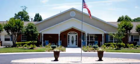 Brookdale Roanoke senior living facility front entrance with flagpole and landscaped grounds.