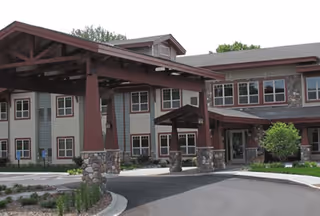 Exterior view of Trails of Orono Assisted Living Memory Care with a covered entry.