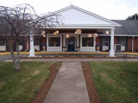 Front exterior of Apple Rehab Coccomo with a covered entrance and balloons.