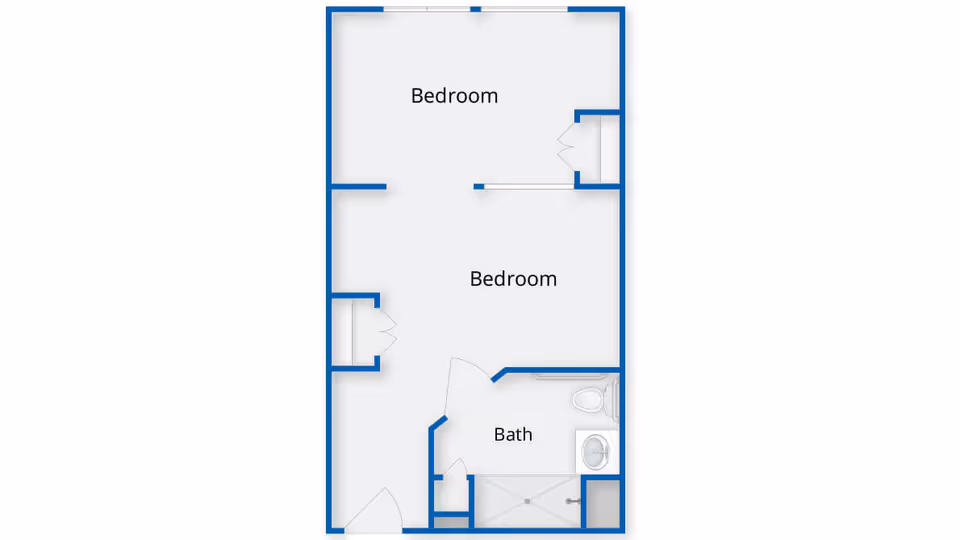 Floor plan layout showing two bedrooms and one bathroom. The plan includes doors and fixtures such as a toilet, sink, and shower in the bathroom.