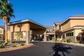 Front view of Marquis Care at Centennial Hills, showing a covered entrance and landscaped driveway.