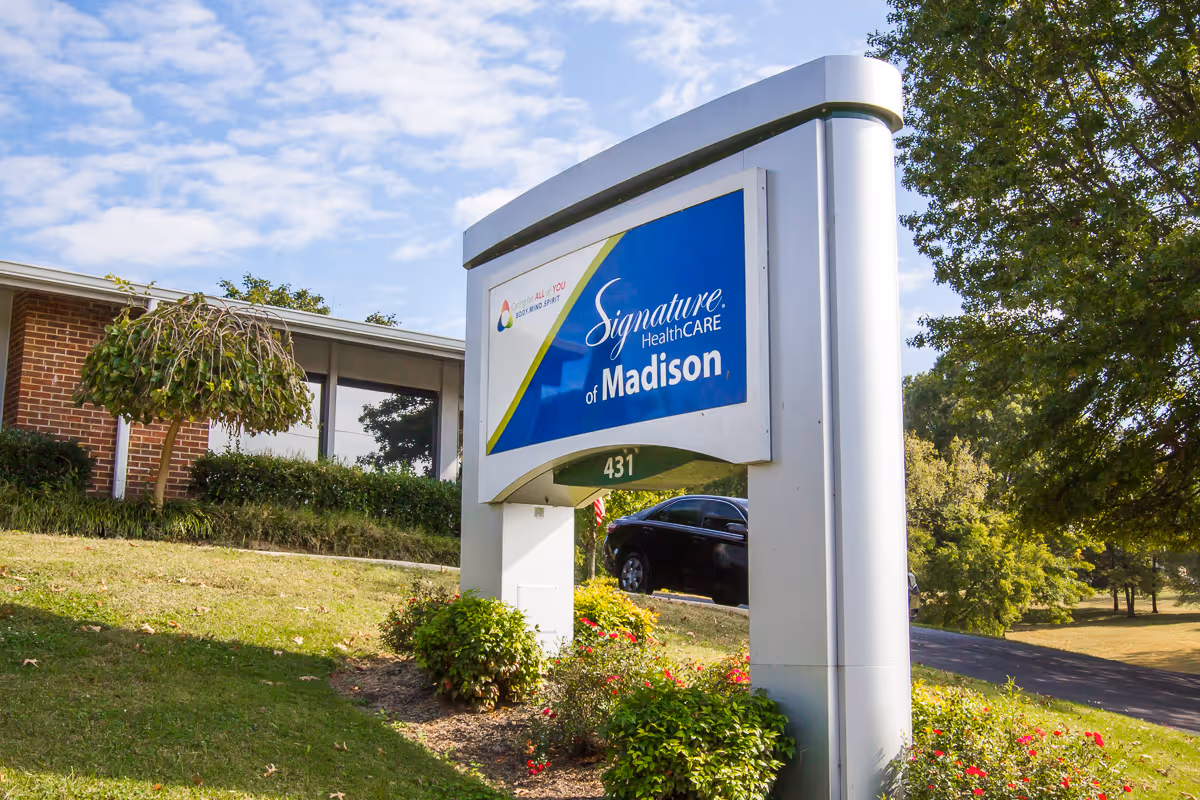 Signage for Signature HealthCARE of Madison with landscaped surroundings.