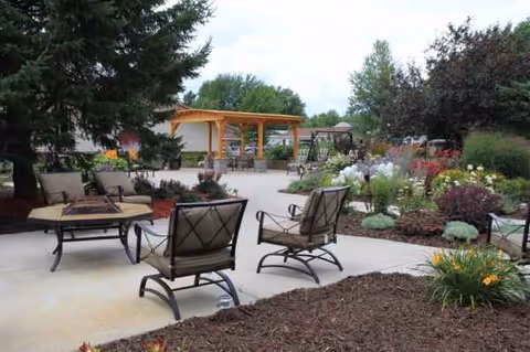 Outdoor courtyard with patio seating, planters, and a wooden pergola.