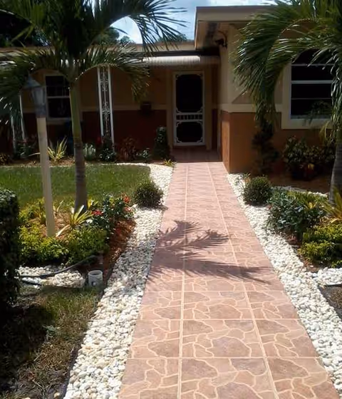 Front walkway leads to Adult Leisure Living, Inc. entrance, surrounded by tropical landscaping.