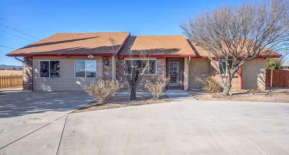 Desert Haven AZ exterior of a single-story front facade with driveway and trees.