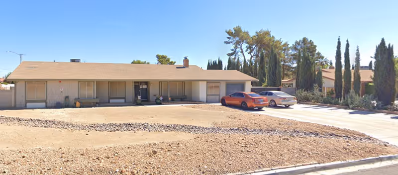 Exterior of Dorothy Graham’s Care Home, single-story building with parked cars and desert landscaping.