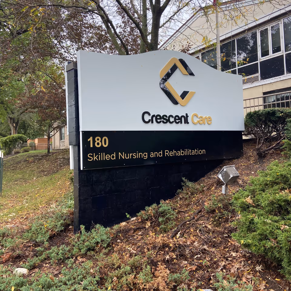 Outdoor sign reading "Crescent Care 180 Skilled Nursing and Rehabilitation" in front of the facility building.