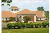 Front exterior of Wesbury United Methodist senior living facility with entrance and landscaping.