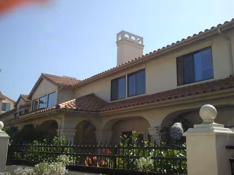 Exterior view of Oakmont of Chino Hills, a beige two-story senior living building with arches.