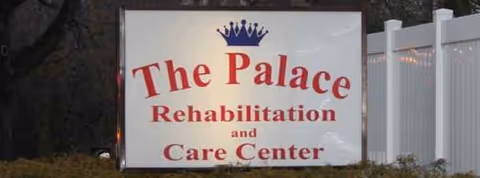 Exterior sign for The Palace Rehabilitation and Care Center beside a white fence.