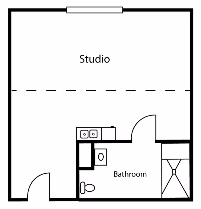 Black-and-white floor plan of a studio apartment showing a main studio area, kitchenette, and a labeled bathroom with a toilet, sink, and shower.