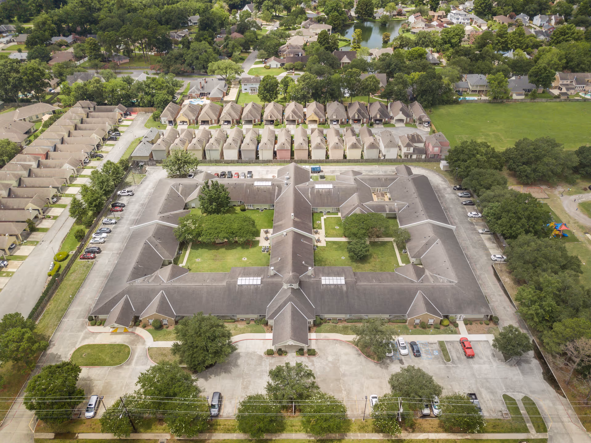 Aerial view of Brookdale Lafayette showing a large U-shaped building around a green central courtyard, parking lots, and surrounding neighborhood.