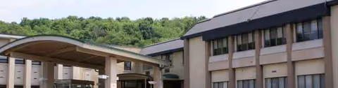 Exterior view of Wexford Healthcare Center with a covered entrance.