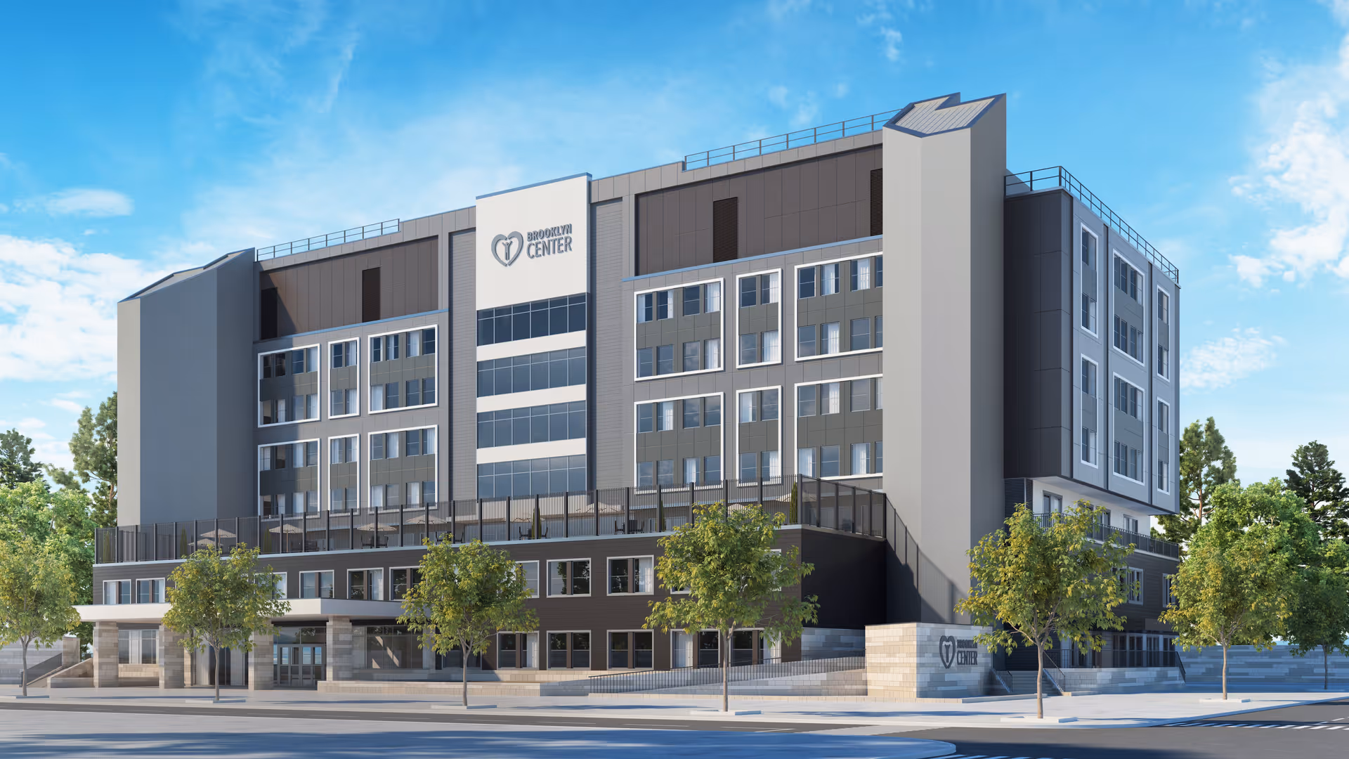 Exterior view of a modern multi-story building labeled Brooklyn Center for Rehabilitation and Nursing, with trees and a clear blue sky in the background.