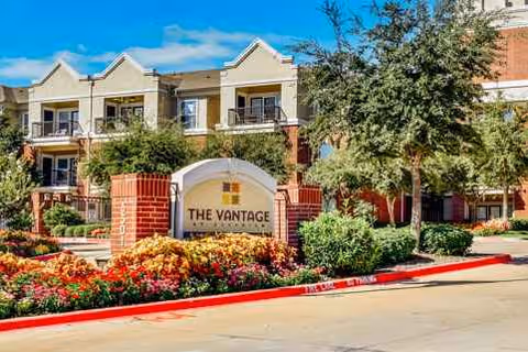 Exterior view of The Vantage at Cityview entrance with landscaping and signage