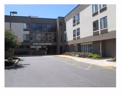 Exterior view of the Complete Care at Court House facility entrance with parking lot.
