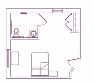 Simple floor plan of a small one-bedroom unit showing a bed and nightstand, a bathroom with toilet and sink, and a closet by the entrance.
