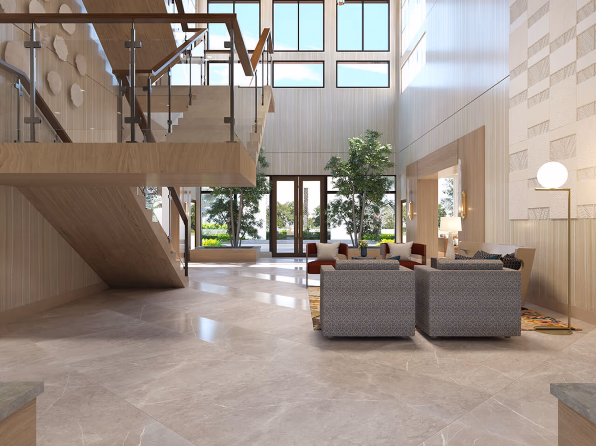 A spacious and modern interior lounge area with large floor-to-ceiling windows allowing natural light to fill the space. The room features a wooden staircase with glass railings on the left, several armchairs and sofas arranged around a rug, indoor plants, and a tall floor lamp on the right. The walls have a light wood paneling and decorative textured panels.