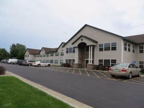 Exterior view of Vista Prairie at Garnette Gardens showing the front entrance and parking lot.