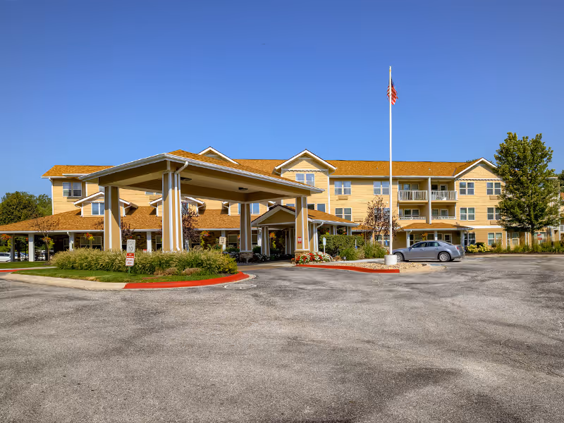 Exterior view of Holiday Rolling Hills Ranch senior living facility with entrance canopy and parking.