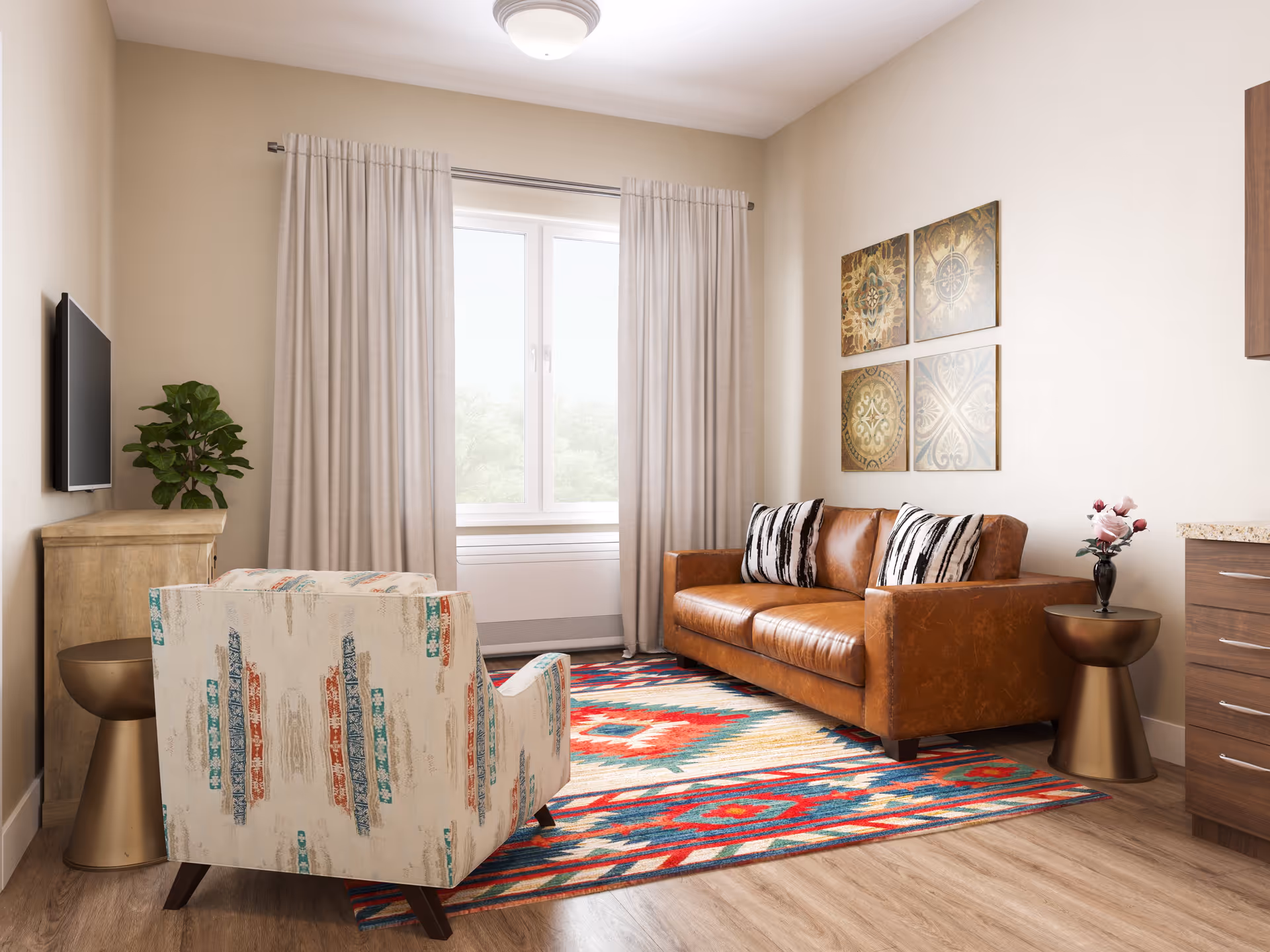 A cozy living room with a brown leather sofa adorned with two black and white patterned pillows, a colorful patterned rug on the wooden floor, a patterned armchair, a small round bronze side table with a vase of flowers, a wooden cabinet with a green plant, a wall-mounted flat-screen TV, and four decorative square wall art pieces above the sofa. Light beige curtains frame a window letting in natural light.