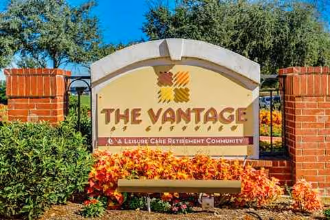 Bright sign reading The Vantage at Cityview surrounded by brick pillars and flowers.