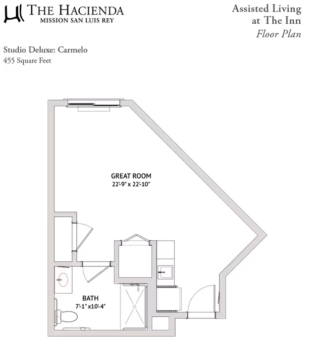 Floor plan of a studio deluxe apartment named Carmelo at The Hacienda Mission San Luis Rey assisted living facility, showing a 455 square feet layout with a main living area, bathroom with toilet and sink, and a small kitchen area with a sink.