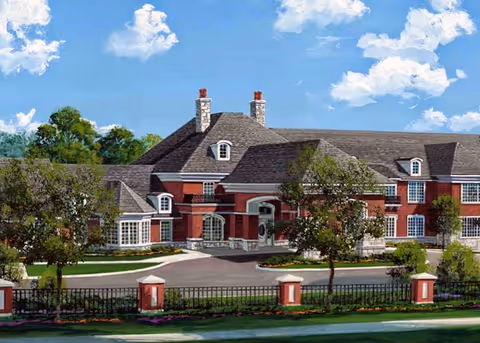 Front exterior of a large red-brick senior living building with a circular driveway, trees, and a wrought-iron fence.