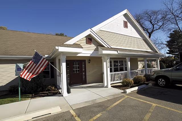 Front view of Brookdale Middleton Century Ave facility with flag at entrance.