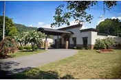Exterior view of Marshall Manor Nursing & Rehab Center with driveway and landscaped grounds.