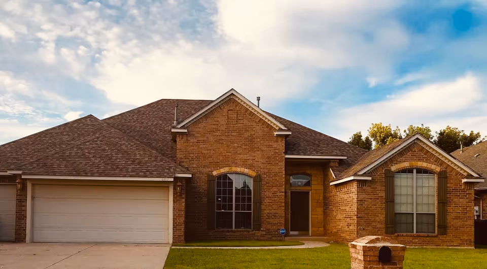 Brick, single-story home with a two-car garage and well-kept front lawn.