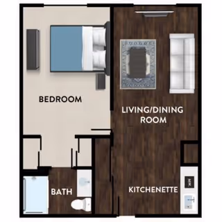 Floor plan of a senior living unit at Kipling Meadows Senior Living showing a bedroom with a bed and TV, a bathroom with a bathtub and toilet, and a combined living/dining room with a sofa, coffee table, and kitchenette area.