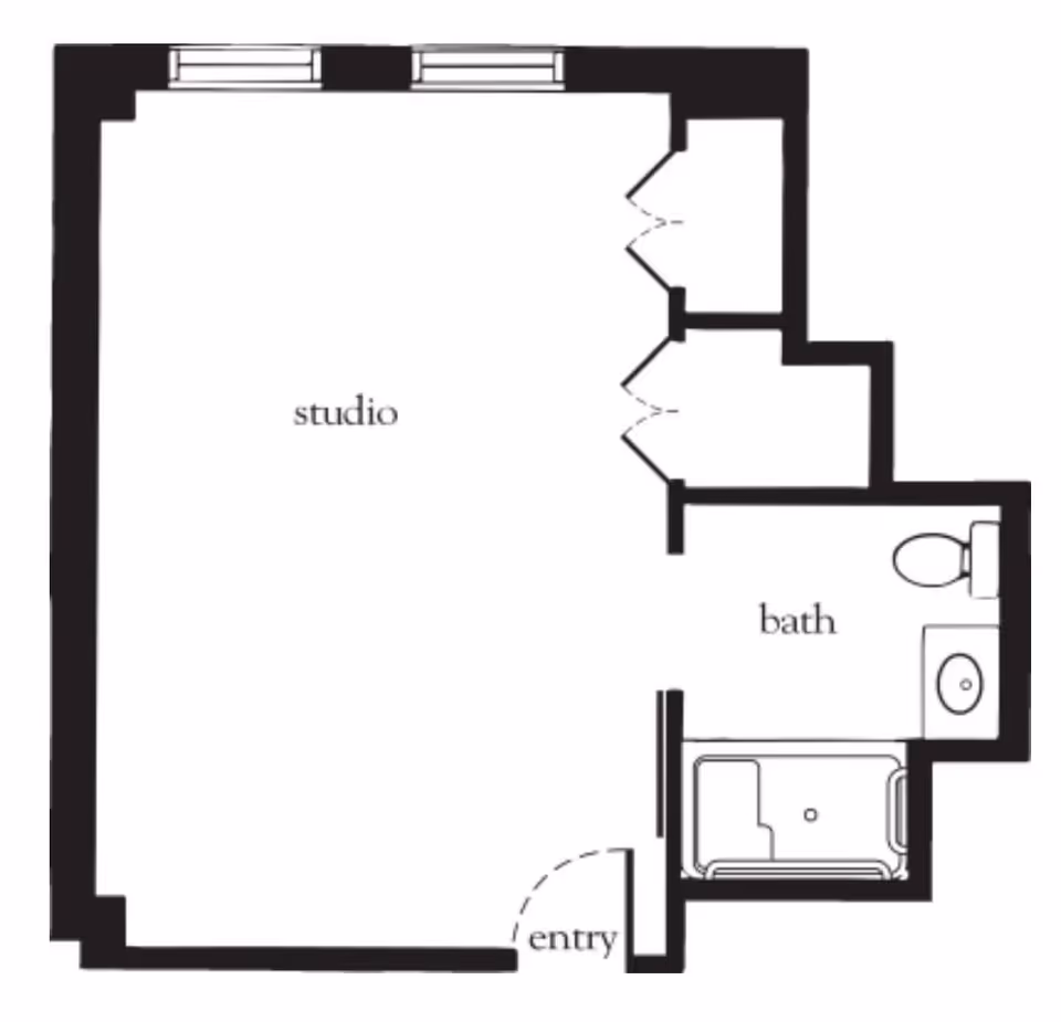 Floor plan of a studio apartment with an entryway, a main studio living area, and a bathroom that includes a toilet, sink, and bathtub.