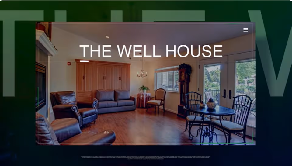 A cozy living room with wooden flooring, featuring a brown leather armchair, a gray sofa, a wooden cabinet, a small round table with two chairs near glass doors leading outside, and a grandfather clock by the window.
