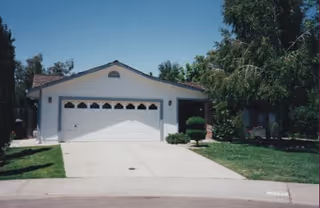 A single-story house-style facility with a white garage and well-kept lawn.