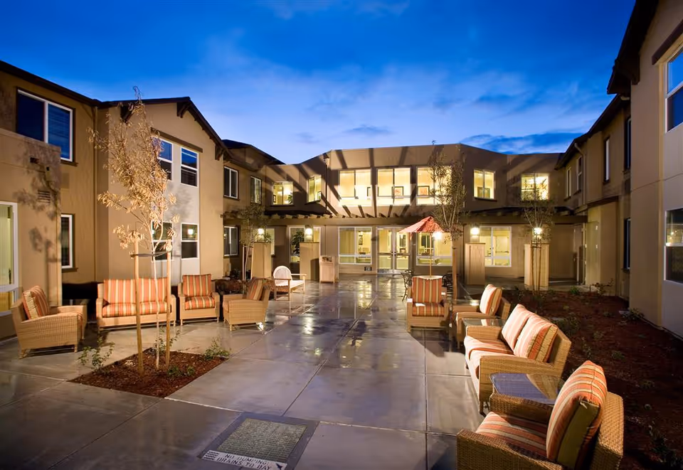 Outdoor courtyard of The Parkview with wicker seating and warm evening lighting.