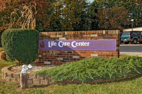 Brick sign reads Life Care Center Sullivan on a landscaped front yard.