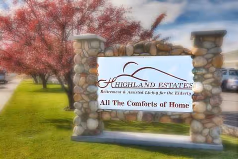 Exterior stone sign for Highland Estates Assisted Living and Memory Care with slogan.