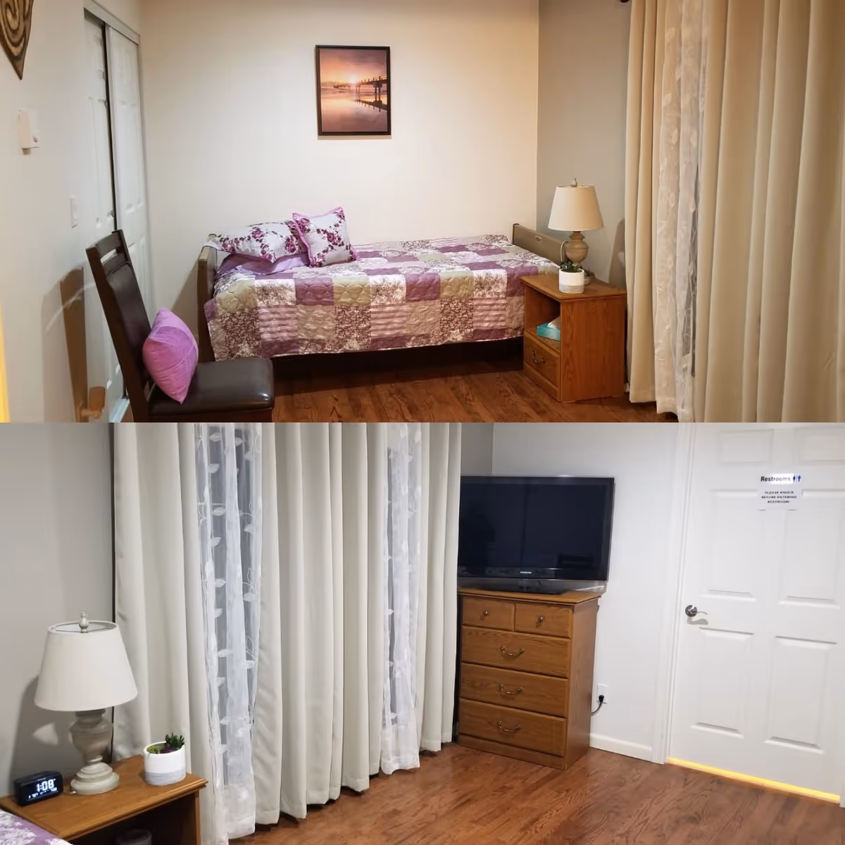 Small furnished bedroom with a single bed, nightstand and lamp, dresser with TV, chair, and floor-to-ceiling curtains.