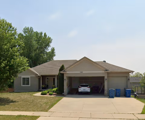 Front view of a single-story suburban home with a two-car garage and driveway.