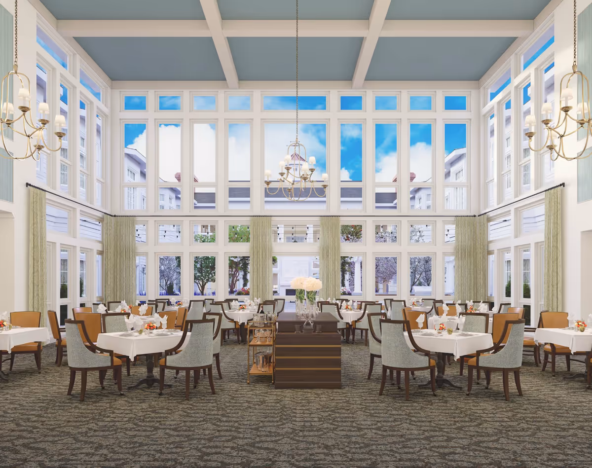 Spacious bright dining room with high ceilings, floor-to-ceiling windows, chandeliers, and neatly set tables.