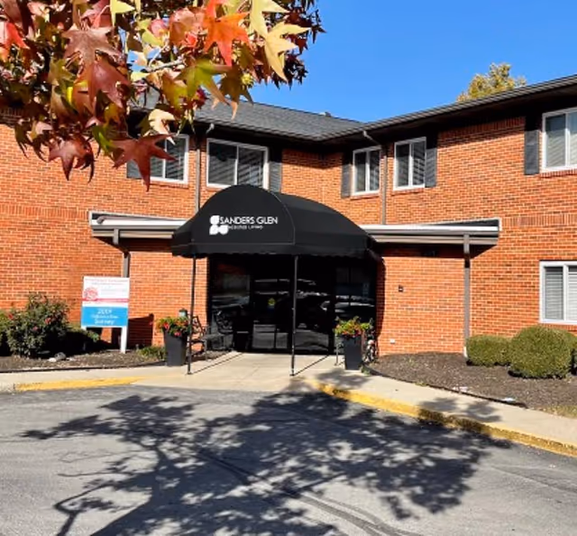 Brick building with a black canopy over the entrance at Sanders Glen Assisted Living Center.
