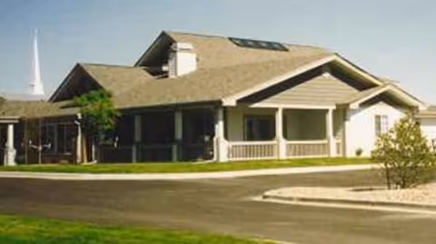 Exterior view of Prairie Creeks Living Center building with a covered front porch.