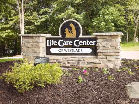 Stone entry sign for Life Care Center of Westlake with trees in background