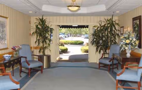 Interior lobby of Alliance Health at West Acres with seating, plants, and an outdoor exit.