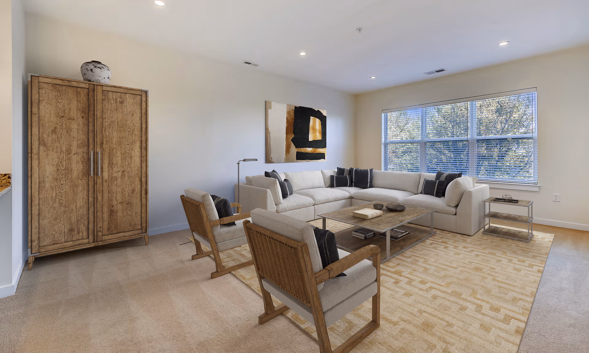 Bright living room with a large beige sectional sofa, coffee table, two armchairs, a wooden cabinet, and a large window.